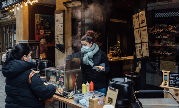 A woman serves food in the Latin Quarter of Paris. The unemployment rate in France is now below pre-pandemic levels.