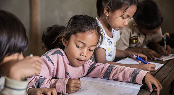 Young Cambodian students taking English lessons. Cambodia’s primary school enrollment rate is nearly 100%, a result of increased public spending on education in the country. (photo: Yongyuan Dai/istock photos)