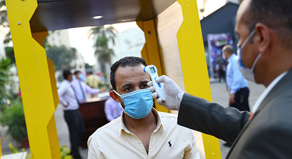 A man has his temperature checked before entering a building. The pandemic has had a large impact on countries in the Middle East and Central Asia. (photo: CHINE NOUVELLE/SIPA/Newscom)