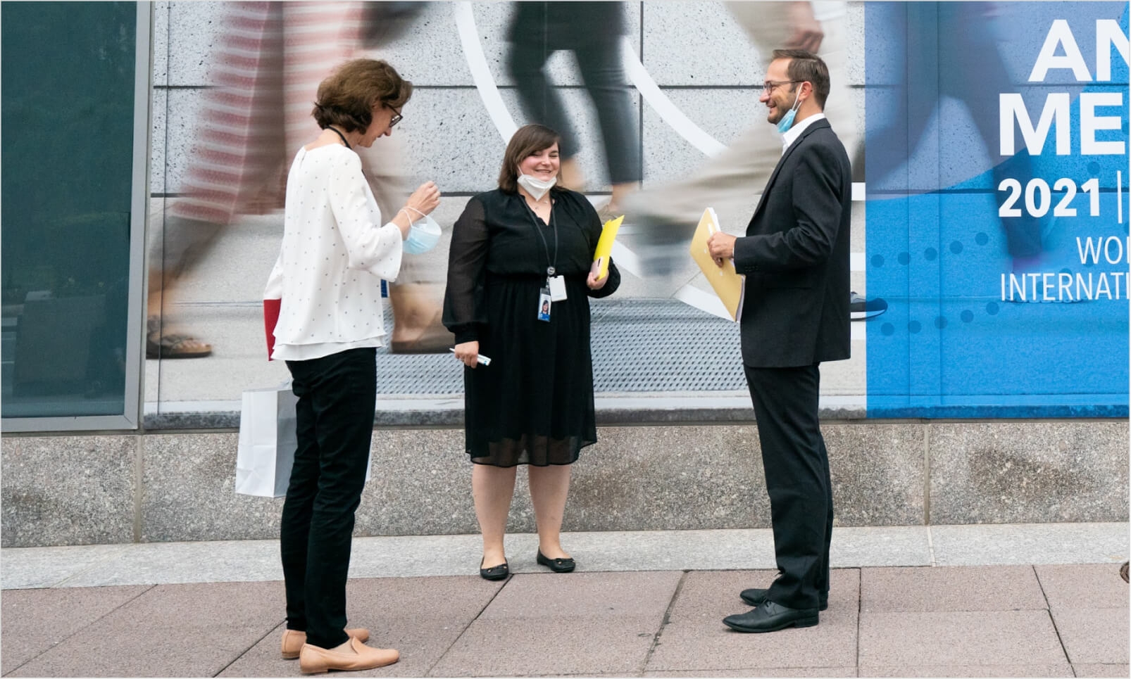 A male and two female colleagues on a sidewalk in Washington, D.C.