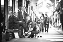 Businessman gets his shoes shined in London, United Kingdom.