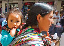 Peruvian woman carrying her child.