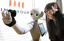 Humanoid robot Pepper takes selfie during app contest, Tokyo, Japan.